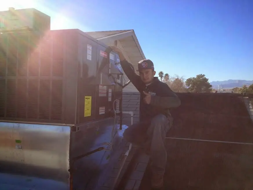 HVAC technician performing Air Duct Cleaning on a rooftop unit in Mount Rainier